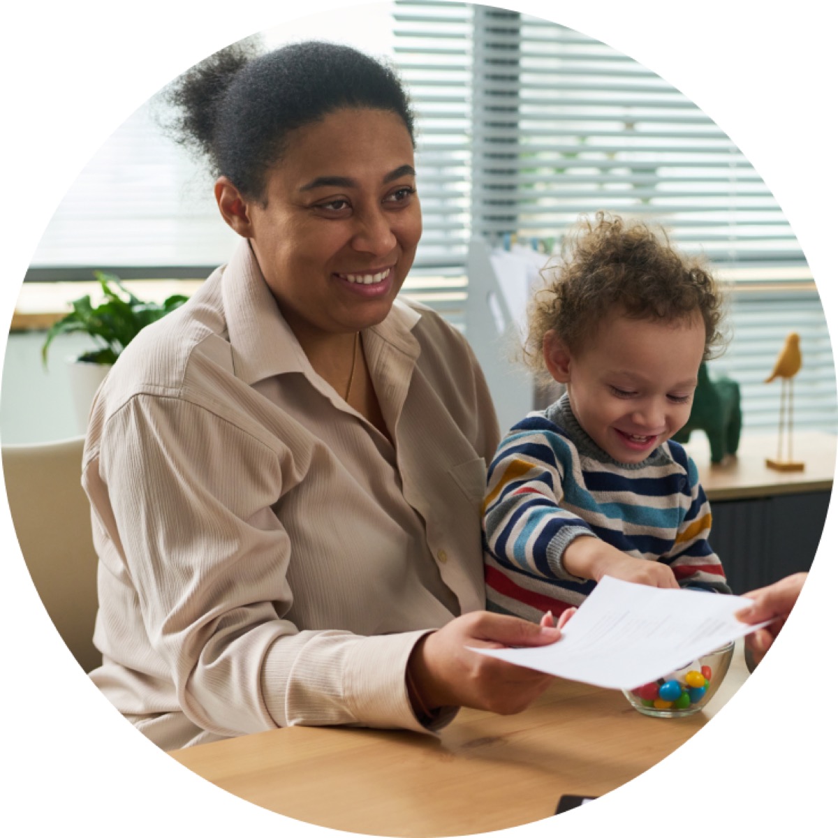 A parent and toddler looking at a picture book together